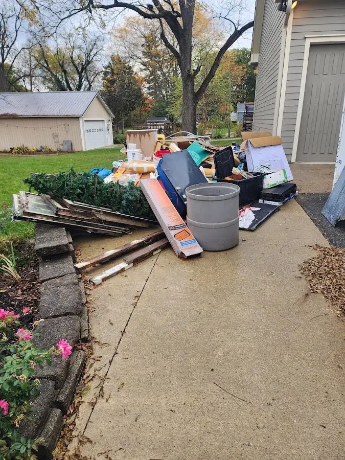 Dumpster being loaded with debris for Estate Cleanout Dumpster Rental in Sterling